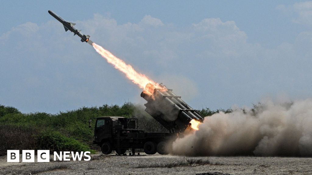 Japan defence minister denies militarism and criticises China's 'huge arsenal'