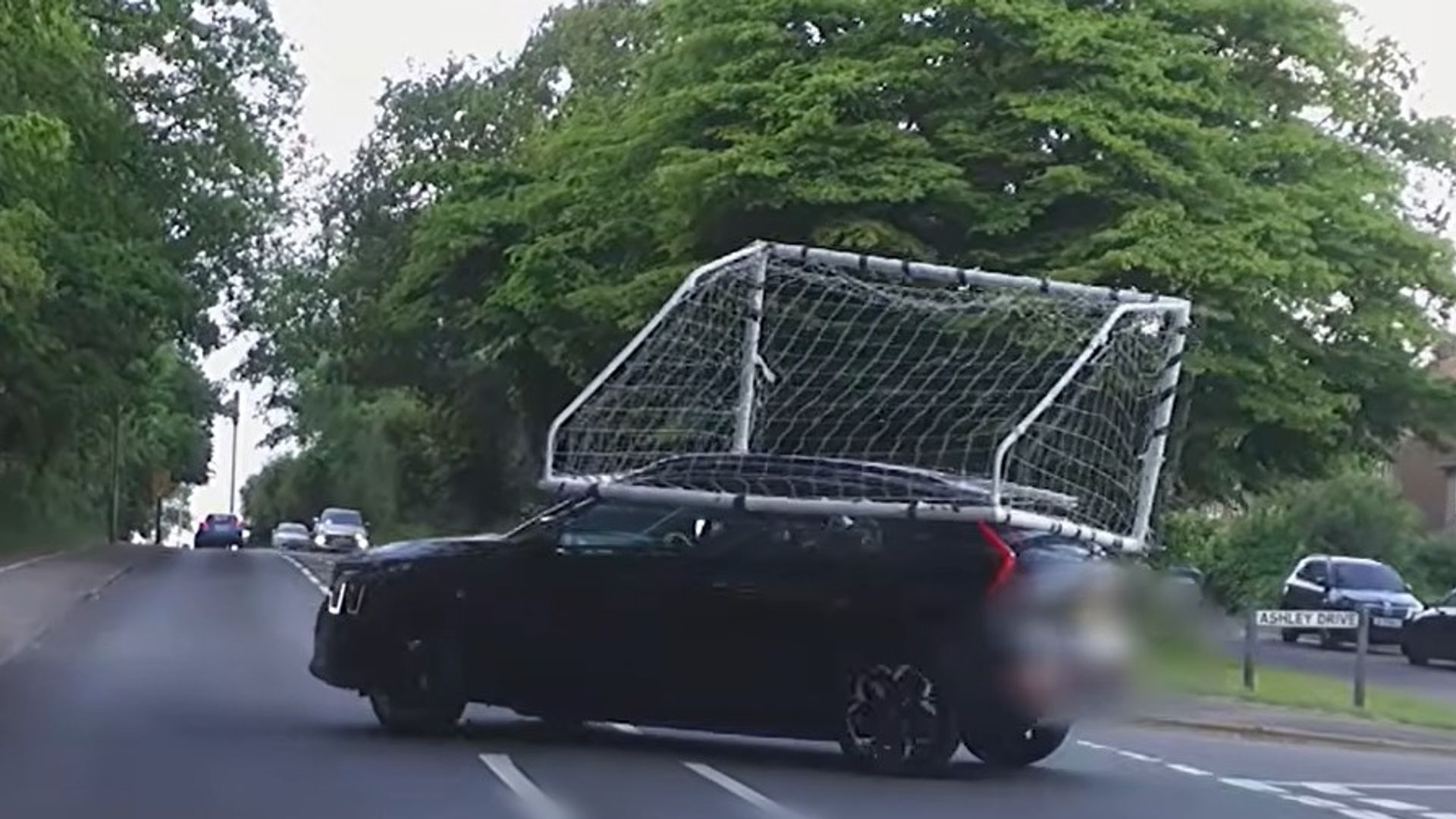 Police share 'own goal' footage of driver with football net on top of car