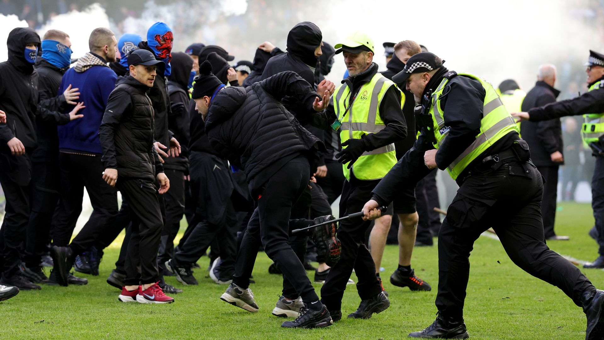 Rangers and Celtic fans in 'shameful' clashes on pitch after cup tie